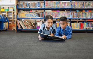 A photo showing two students from Sacred Heart Cabramatta reading in the school library